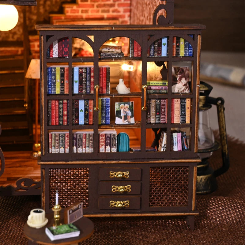 Bookshelf with miniature books and photos in a cozy book nook.