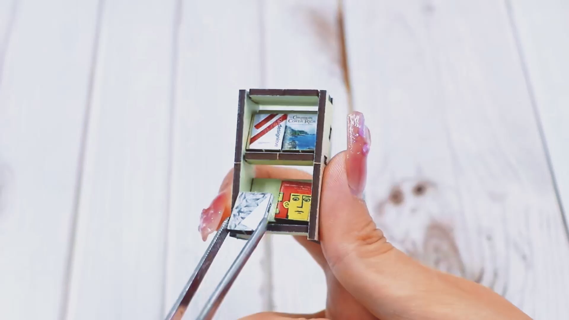 Close-up of miniature bookshelf assembly in book nook kit